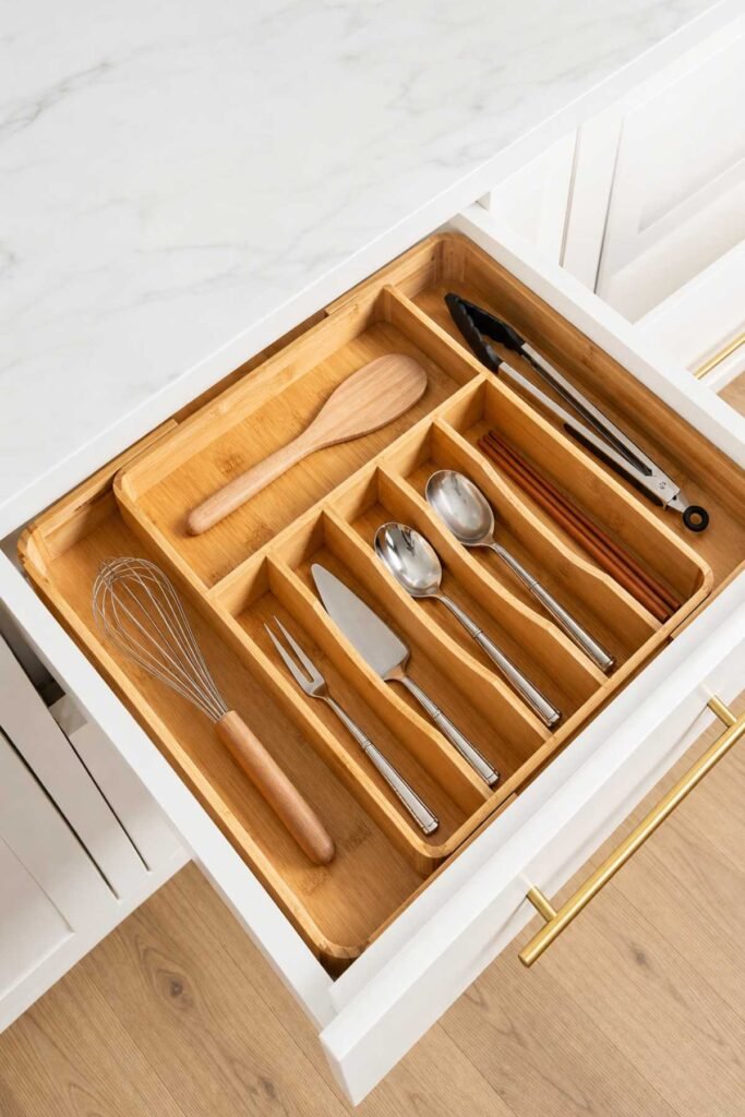 Kitchen drawer neatly divided with organizer sections for utensils and tools